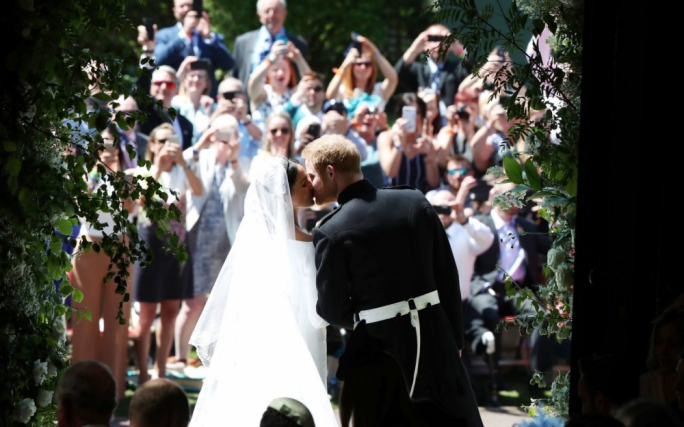 The newlyweds share a kiss to the delight of onlookers